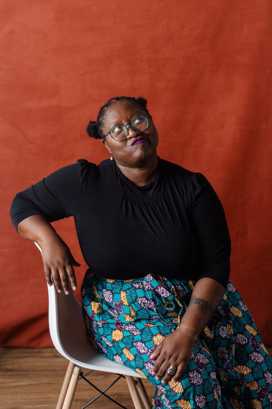 Alexis Appollonia Robinson seated, looking aside